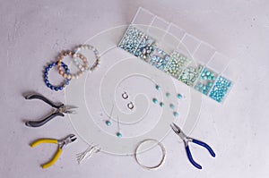 Making of handmade jewellery. Top view. Beads, tools for creating jewelry. Preparation for handmade. Create jewelry, bracelets