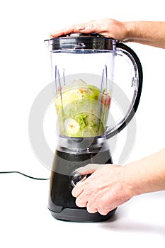 Making a healthy avocado smoothie with a blender