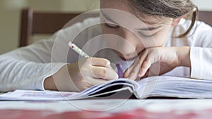 The elementry student is making her homework