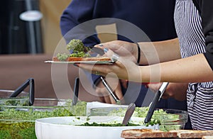 Making herb toast with green pesto spread at the Prague farmers market