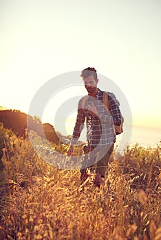 Making his way through nature. a handsome young man enjoying a hike.