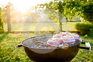 Making home made Beer Can Bacon Burgers on barbecue grill.