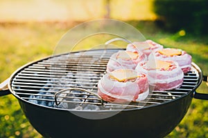 Making home made Beer Can Bacon Burgers on barbecue grill.