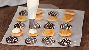 Making Homemade Cookies with Apricot Jam and Whipping Cream. Hand with confectionery bag squeezing cream filling to