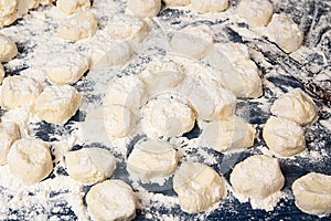 Making homemade gnocchi. Uncooked trickled pastries in flour