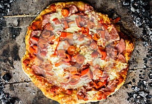 Making of homemade Italian pizza in fireplace brick oven