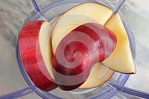 Making juice with apple fruit, blender top view.