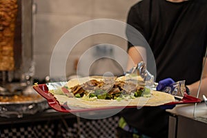 making a kebab in a restaurant chicken salad in rollo photo