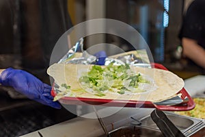 making a kebab in a restaurant chicken salad in rollo photo
