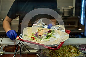 making a kebab in a restaurant chicken salad in rollo photo
