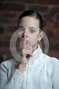 Making a keep it quiet gesture