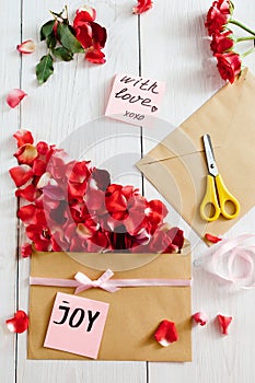 Making love message with envelope and rose petals