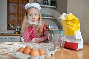 Making a mess is half the fun. a little girl baking in the kitchen.