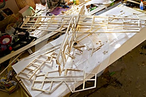 Making model airplane from balsa wood. handcrafted on work table photo