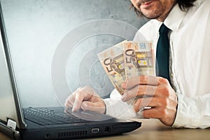 Making money online, businessman with laptop computer