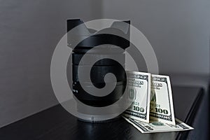 Making money on photography. Photographer`s income. Money camera. Concept money lens