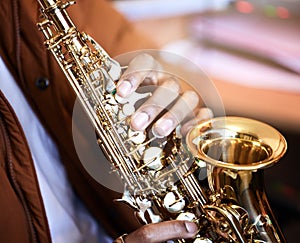 Making music with air. Cropped shot of an unrecognizable male musician playing his saxophone at home.