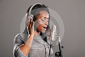 Making music beautiful black woman singing in mic photo