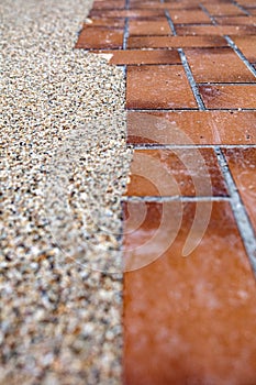 Making a new terrace floor with a bright stone carpet of marble pebbles, old stone tiles below