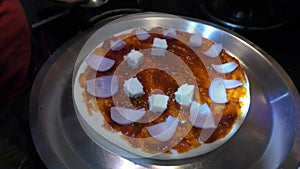 Making onion and cheese pizza at home