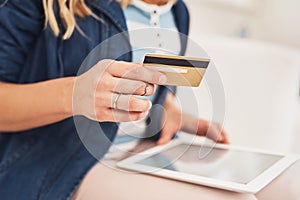 Making online purchases has never been more convenient. Closeup shot of a woman making a credit card payment on a