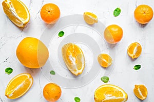 Making orange juice with mint on table background top view patte