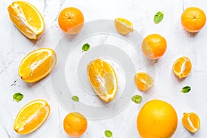 Making orange juice with mint on table background top view patte