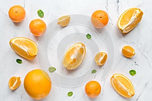 Making orange juice with mint on table background top view pattern