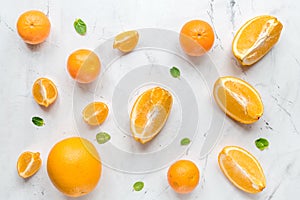 Making orange juice with mint on table background top view pattern