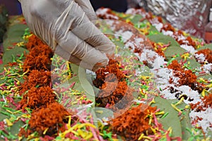 Making Paan, betel quid, at market stall