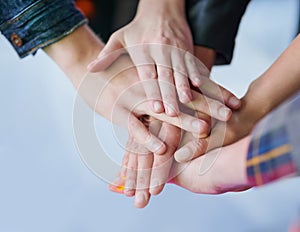 Making a pact to stay friends forever. Shot of a group of unidentifiable friends making a pact by putting their hands in