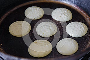 Making pancakes on frying pan top view