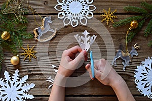 Making paper snowflakes with your own hands. Children& x27;s DIY. Merry Christmas and New Year concept. Step 2. Cut the snowflake