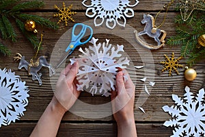 Making paper snowflakes with your own hands. Children& x27;s DIY. Merry Christmas and New Year concept. Step 3. Open the snowflake