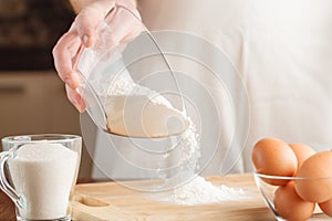 Making Pastry Dough for Hungarian Cake. A baker pouring baking p