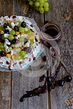 Making a Pavlova dessert with fruit and jam