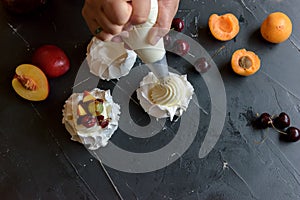 Making a Pavlova dessert with fruit and jam