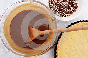 Making pecan pie - stirring the filling with a wooden spoon