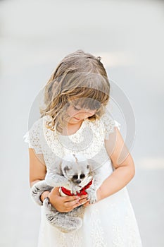 Making photo of exotic animals. Little girl with lory lemur.