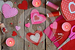 Making pink and red hearts of felt with your own hands. Valentines Day background. Valentine gift making, hobby. Childrens DIY