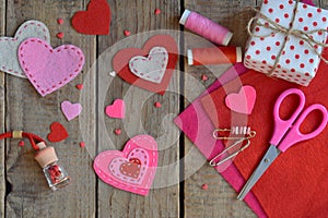 Making pink and red hearts of felt with your own hands. Valentines Day background. Valentine gift making, hobby. Childrens DIY con