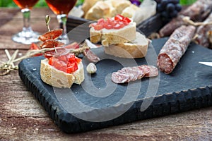 Making pintxo with tomato and sausages, tapas, spanish canapes party finger food