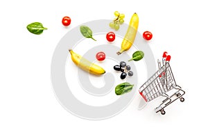 Making purchase online with mini trolley and products on white desk background top view mock up