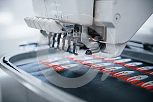Making rocket pictures. Close up view of white automatic sewing machine at factory in action photo
