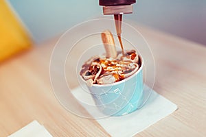 Making of rolled ice cream on a still chilled pan.