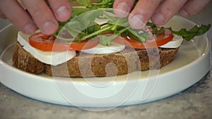 Making a sandwich with cheese. Close-up with male hands