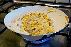 Making scrumbled eggs in a pan