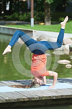 Making shirshasana outdoors