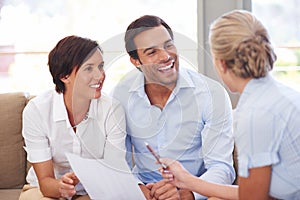 Making smart investment choices. Shot of a financial advisor explaining documents to a couple.