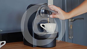 Making specialty compostable capsule coffee with Nespresso coffee machine. High-quality jpg image.